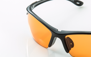 protective eyewear | photo of protective eyeglasses with an orange lens