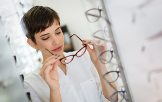 low price vs. high price glasses | photo of young woman shopping for glasses